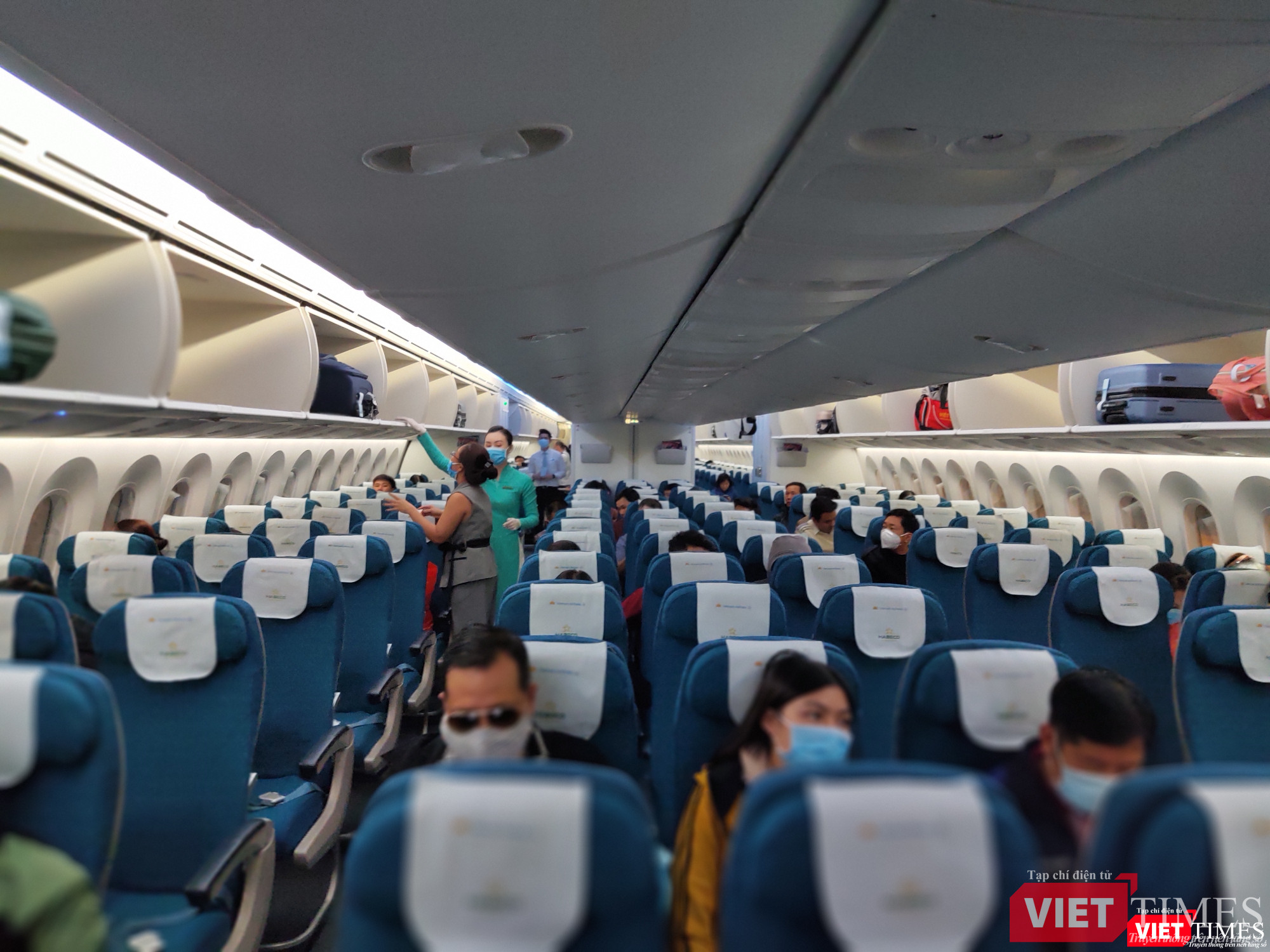 Tiếp viên và hành khách đều đeo khẩu trang trên máy bay