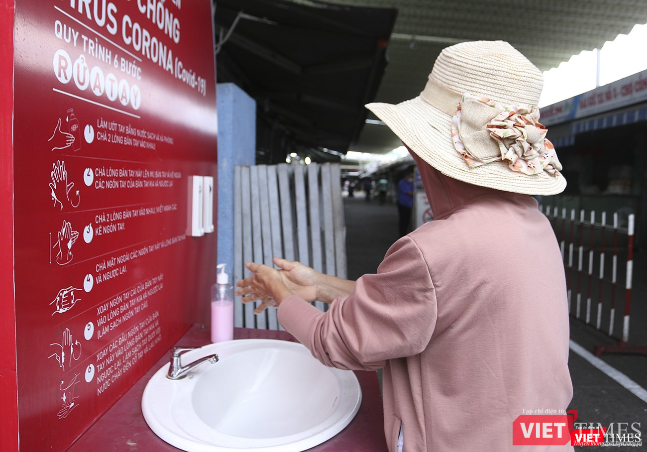 Người dân tuân thủ việc rửa tay, đeo khẩu trang trước khi vào chợ