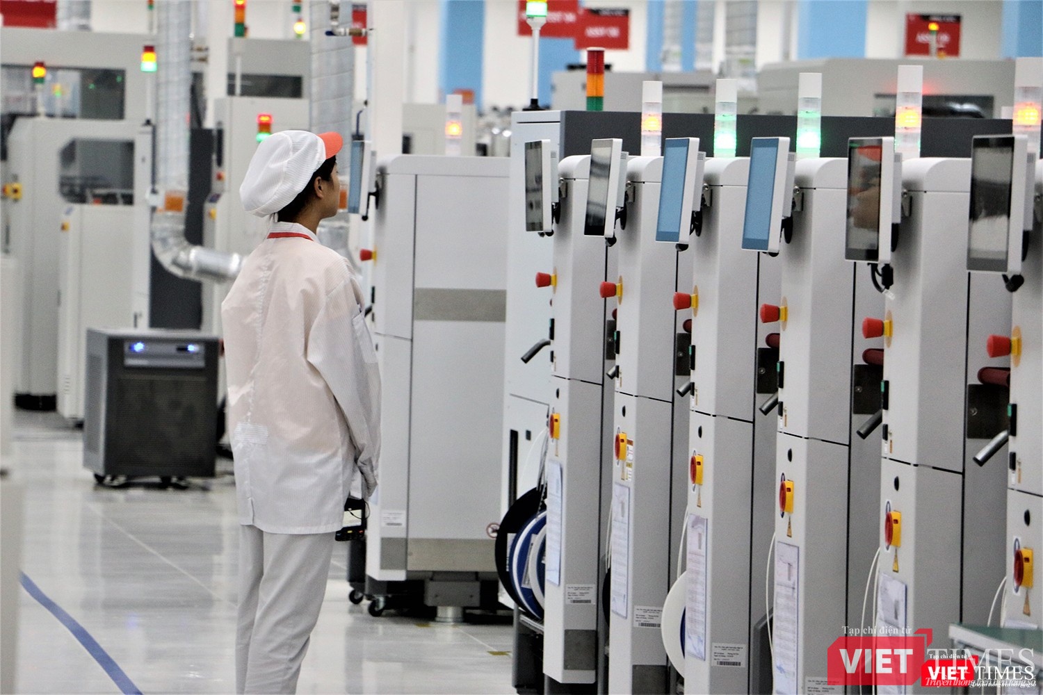 Một công nhân đang theo dõi quá trình sản xuất bảng mạch in