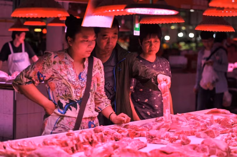 Khách hàng mua thịt lợn tại một chợ truyền thống ở Bắc Kinh hôm 5/9 (Ảnh: AFP)