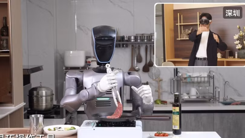 Một người đàn ông đeo kính VR điều khiển từ xa một robot của hãng Shenzhen Dobot từ khoảng cách 1.800 km. Ảnh: Handout.
