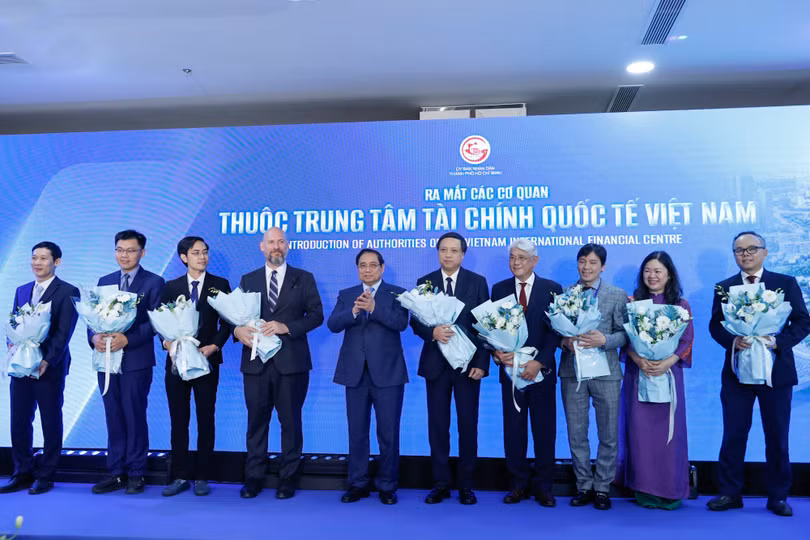Thủ tướng Phạm Minh Chính tặng hoa cho đại diện các cơ quan thuộc Trung tâm Tài chính quốc tế Việt Nam. Ảnh: VGP/Nhật Bắc