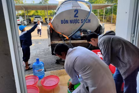 Nhân viên y tế Cơ sở Chân Mây - Trung Tâm y tế Phú Lộc hứng nước sinh hoạt từ xe bồn tiếp nước của HueWaco sau khi cơ sở mất nước hoàn toàn chiều 26/8. Ảnh: NL.
