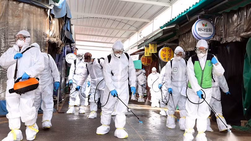 Các nhân viên phòng dịch khử trùng trong khu chợ ở Gyeongbuk (Ảnh: Yonhap)