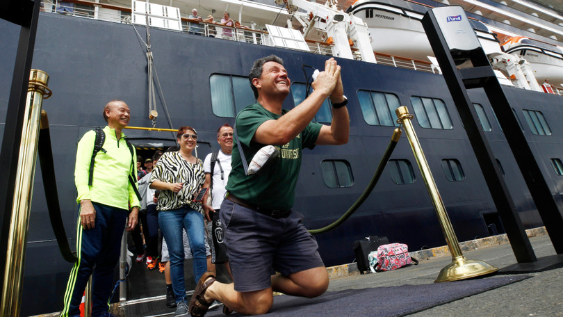 Một hành khách không kìm nén được sự sung sướng khi được lên bờ sau nhiều ngày lênh đênh trên biển (Ảnh: AP) Một hành khách không kìm nén được sự sung sướng khi được lên bờ sau nhiều ngày lênh đênh trên biển (Ảnh: AP)