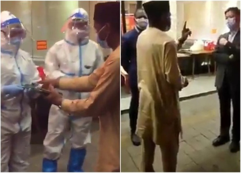 Đại diện Lãnh sự quán Nigeria tại Quảng Châu tranh cãi với các nhân viên công vụTrung Quốc đòi trả lại hộ chiếu họ đã tịch thu của các công dân nước ông (Ảnh: Đông Phương).