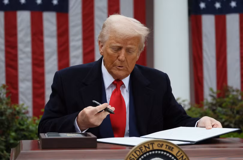 Tổng thống Mỹ Donald Trump ký lệnh hành pháp về thuế quan tại Vườn Hồng thuộc Nhà Trắng ngày 2/4. Ảnh: Reuters.