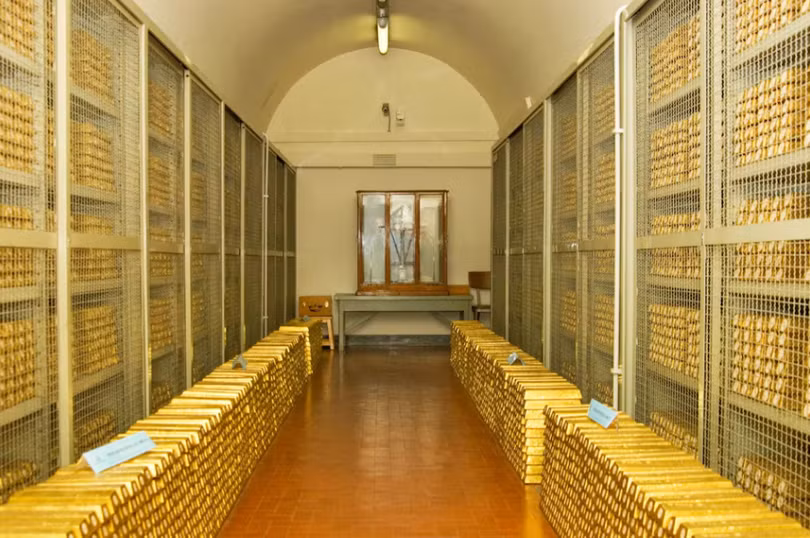 Một căn phòng an toàn bên trong hầm vàng của Ngân hàng Italy chứa đầy những thỏi vàng xếp chồng lên nhau, phía sau là những chiếc lồng an toàn chứa vàng. Ảnh: Reuters.