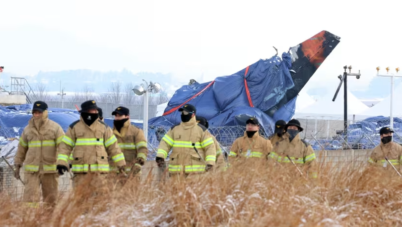 Tấm bạt phủ lên mảnh vỡ của chiếc máy bay Boeing 737-800 của hãng hàng không Jeju Air, bị rơi và bốc cháy vào ngày 29/12/2024 tại Sân bay Quốc tế Muan, cách Seoul khoảng 288 km về phía tây nam. Ảnh: AFP.
