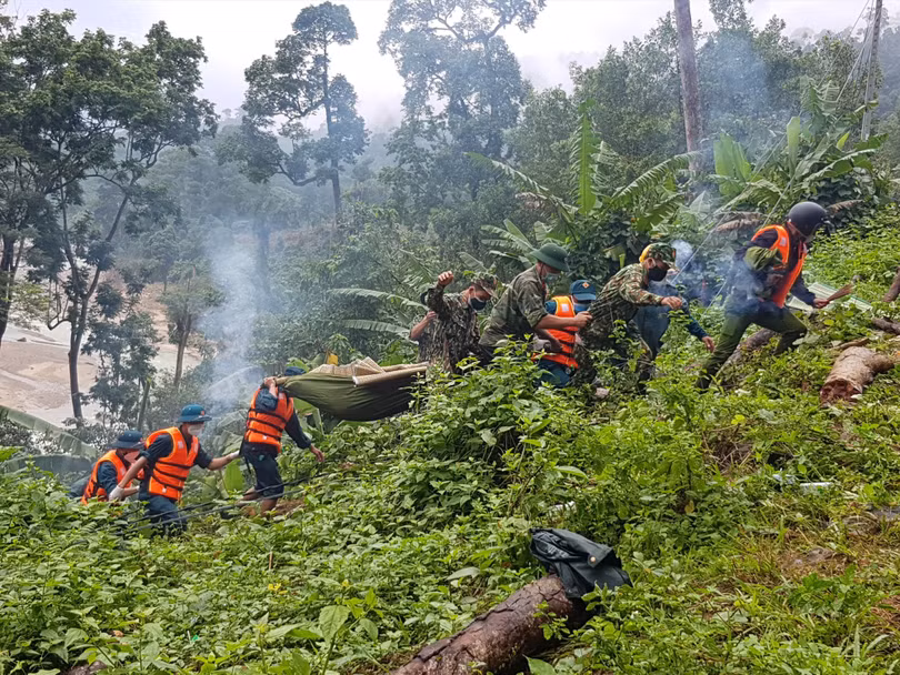 Các lực lượng tìm kiếm cứu nạn đưa thi thể nạn nhân về gia đình an táng (Ảnh: Hoàng Thọ)