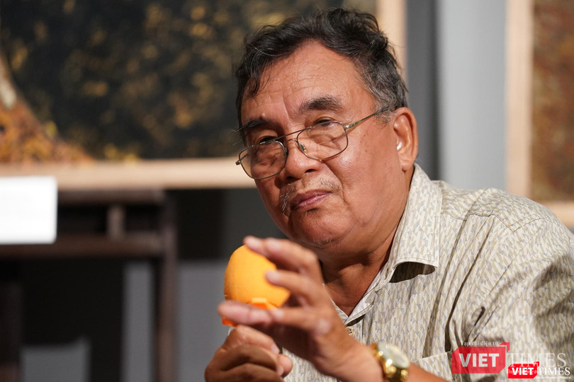 Họa sĩ Lê Xuân Chiểu nói về tranh sơn mài của Trần Ngọc Hưng. Ảnh: Phạm Nguyễn