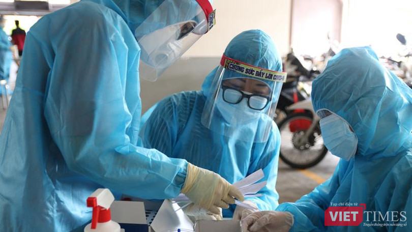 Lấy mẫu xét nghiệm trong vùng phong toả vì BN COVID-19 - Ảnh: HCDC