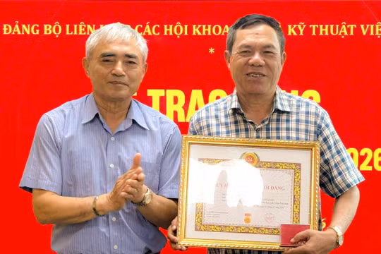 Ông Nguyễn Minh Hồng trao Huy hiệu 40 năm tuổi Đảng cho nhà báo Lê Đức Sảo tại buổi lễ.