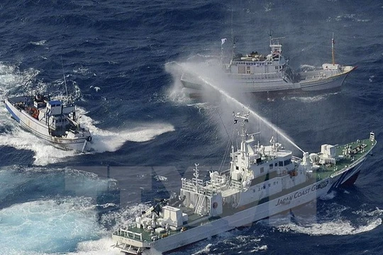 Tàu bảo vệ bờ biển Nhật Bản (phải) phun nước vào các thuyền của Đài Loan tại vùng biển Hoa Đông. (Nguồn: AFP/TTXVN)