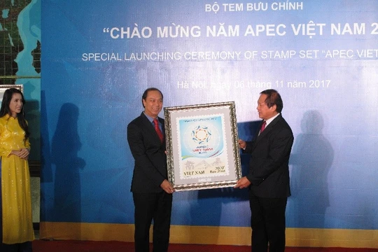 Bộ trưởng Bộ TT&TT trao tặng tem cho Thứ trưởng Bộ Ngoại giao Nguyễn Quốc Dũng. Ảnh: Ánh Dương.