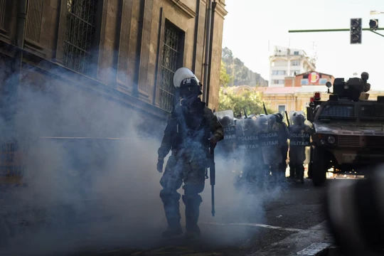 Một thành viên của lực lượng cảnh sát vũ trang đi giữa hơi cay khi Tổng thống Bolivia Luis Arce "tố cáo việc huy động bất thường" một số đơn vị quân đội nước này tại La Paz, Bolivia ngày 26/6 (Ảnh: Reuters)
