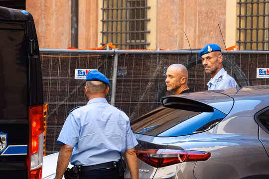 Cảnh sát áp giải nghi phạm đánh bom đường ống Nord Stream Sergey Kuznetsov tại Bologna, Italy vào ngày 22/8. Ảnh: Getty.