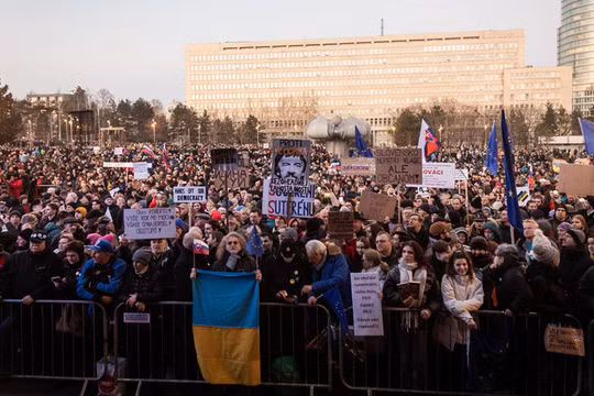 Một người phụ nữ cầm cờ quốc gia Ukraine được nhìn thấy giữa những người biểu tình ở Bratislava, Slovakia, vào ngày 24/1. Ảnh: Getty.