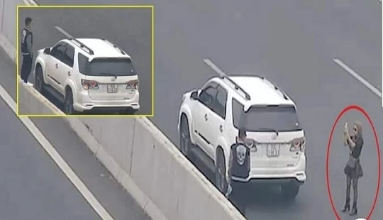 Ảnh cắt từ video ghi lại thời điểm cặp đôi dừng trên cao tốc để sống ảo. Ảnh: Facebook.