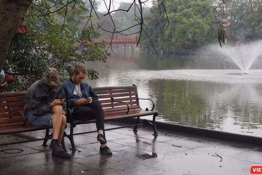 Khách du lịch tận hưởng khoảng lặng hiếm hoi trên đường phố Hà Nội.