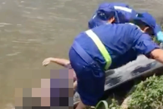 Lực lượng chức năng đang đưa thi thể nạn nhân lên bờ.