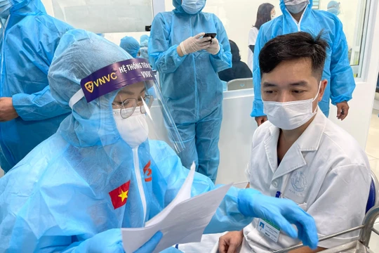 Nhân viên y tế kiểm tra hồ sơ chuẩn bị tiêm vaccine phòng COVID-19 (Ảnh - Tuấn Dũng) 