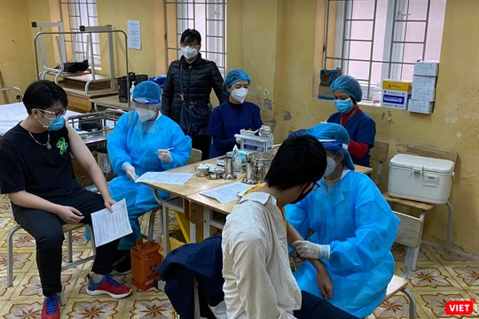 Học sinh được khám sức khoẻ trước khi tiêm vaccine COVID-19 (Ảnh - Quang Hùng) 