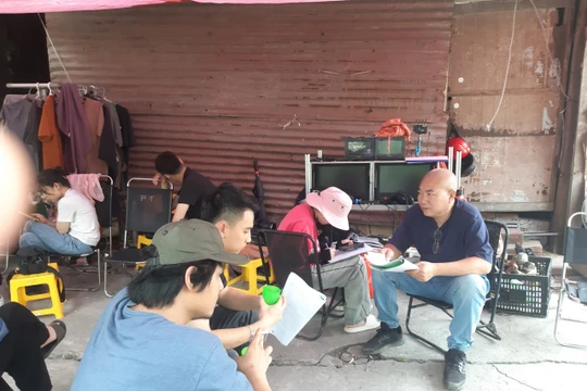 Đạo diễn Nguyễn Danh Dũng (người ngồi ngoài cùng bên phải) đang hướng dẫn diễn viên đọc lời thoại. (Ảnh AT)