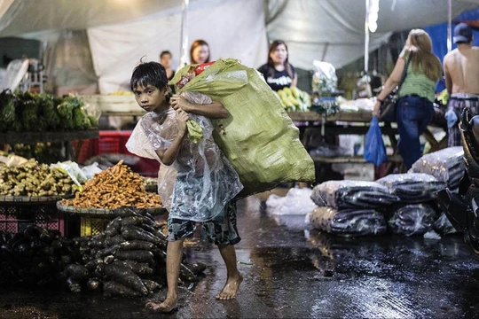 Một em bé vất vả mưu sinh kiếm sống