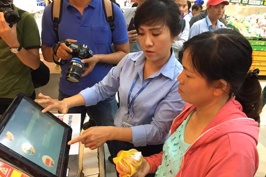 Nhân viên Co.opmart Foodcosa Quang Trung (Gò Vấp) hướng dẫn khách hàng cách kiểm tra nguồn gốc thịt heo bằng máy soi đặt tại siêu thị