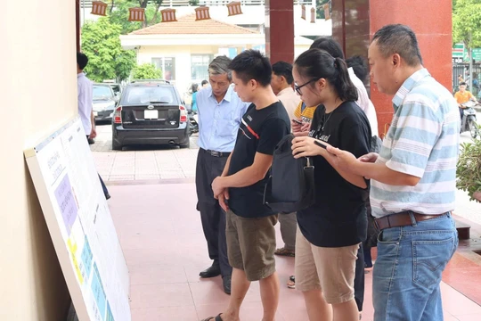 Phụ huynh và học sinh xem thông tin. Ảnh: Minh Thúy