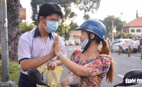 Bà Hồng Nhung (quận Bình Thạnh, TP.HCM) động viên con trai tại kỳ thi vào lớp 10 TP.HCM - Ảnh- NGỌC PHƯỢNG