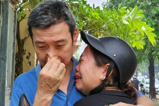 Người thân khóc ngất nhận diện thi thể nạn nhân vụ cháy ở Hà Nội. Ảnh: VietNamNet.