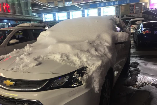 Tuyết phủ trắng nóc các xe đỗ trên đường phố Thường Châu