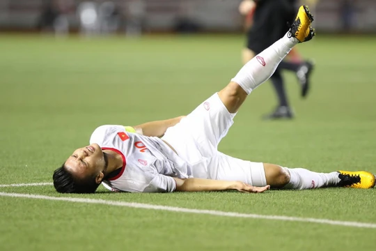 Quang Hải tỏ ra đau đớn sau khi va chạm với Irfan Fandi (ảnh: 24h.com.vn)