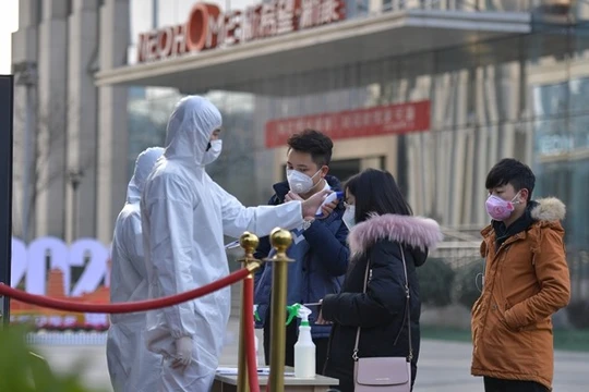 Các công ty thực hiện kiểm tra thân nhiệt nhân viên khi đến làm việc (Ảnh: Đông Phương)