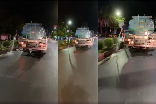 Ảnh cắt từ clip về nhân viên môi trường tưới đường thay vì tưới cây. Ảnh: Facebook