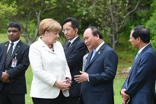 Thủ tướng Việt Nam và Thủ tướng Đức trao đổi bên lề hội nghị.