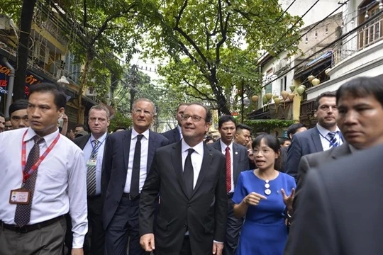 Tổng thống Pháp hòa mình vào dòng người đông đúc đi thăm khu 36 phố phường ở Hà Nội. 