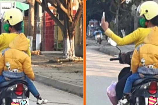 Mẹ đèo con nhỏ vẫn vô tư dùng điện thoại