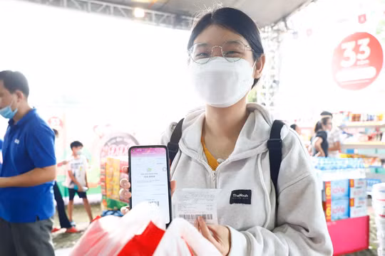 Người dùng trẻ trải nghiệm mua sắm và thanh toán không tiền mặt.