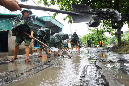Các chiến sĩ thuộc tiểu đoàn 15, sư đoàn 395, Quân Khu III đang dọn dẹp lại đống bùn đất ngổn ngang tại phường Hà Khánh (Quảng Ninh) sau khi nước rút