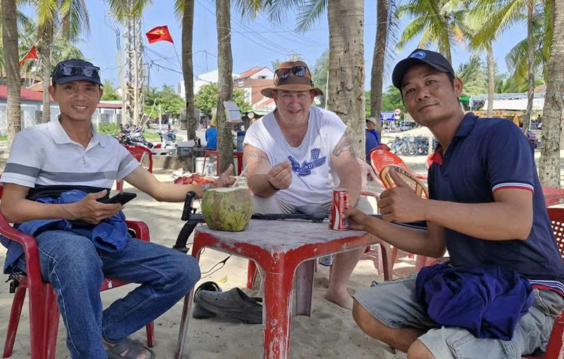 Anh Phan Thanh Trinh cùng bạn và du khách người Australia chung vui khi tìm lại được chiếc nhẫn kim cương bị đánh rơi ở bãi biển Cửa Đại. Ảnh nhân vật cung cấp