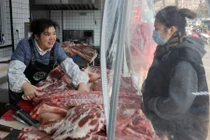 Nhân viên phục vụ khách hàng mua thịt lợn tại một cửa hàng thịt lợn đen ở Thái Châu, tỉnh Giang Tô, Trung Quốc, ngày 16/1. Ảnh: Reuters.