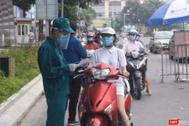 Người dân xếp hàng dài chờ kiểm tra giấy tờ ở chốt kiểm soát phòng, chống dịch COVID-19 (Ảnh - Minh Thuý) 