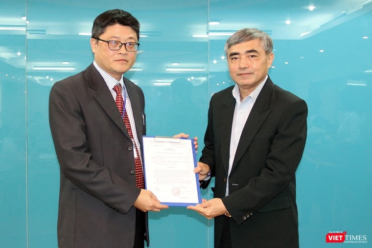 Thứ trưởng Nguyễn Minh Hồng (phải) trao quyết định cho ông Trần Minh. 