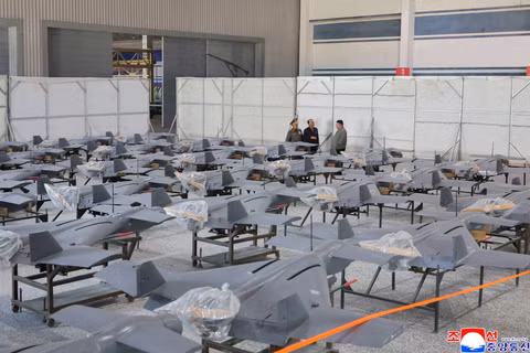 Chủ tịch Kim Jong-un (bên phải) thị sát nhà chứa UAV thành phẩm. Ảnh: KCNA.