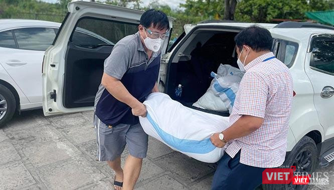 Nhiều tháng nay, "shipper" Bùi Văn Nghĩa (bên trái) nghỉ công việc kinh doanh và rong ruổi xe khắp Sài Gòn để đi chở lương thực, thực phẩm tiếp tế cho các khu vực cách ly, phong toả. Ảnh: GVT.