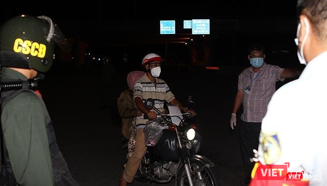 Lực lượng liên ngành nhắc nhở người dân không được ra đường sau 18h hằng ngày. Người đàn ông này giải thích đang đưa người nhà đến bệnh viện, nên được đồng ý cho đi. Ảnh: GVT. Lực lượng liên ngành nhắc nhở người dân không được ra đường sau 18h hằng ngày. Người đàn ông này giải thích đang đưa người nhà đến bệnh viện, nên được đồng ý cho đi. Ảnh: GVT.