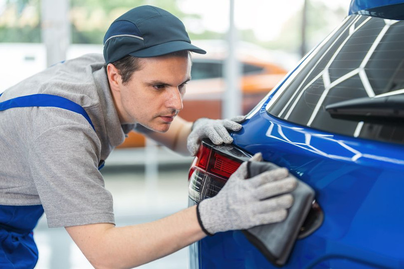 man-using-microfiber-cloth-polishing-car-exterior-royalty-free-image-1684519870.jpg